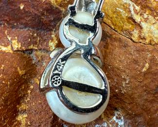 This lot features a 14k gold and pearl snowman pendant with a total approx. weight of 2.00 grams.

