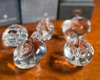 This lot features a collection of five (5) animal themed Steuben Glass sculptures, with five cases to accompany them. Steuben Glass is an American art glass company founded in Corning, New York, in 1903 by Frederick Carder. Originally known for colored glass, it shifted to brilliant clear crystal in the 1930s after being acquired by Corning Glass Works (now Corning Inc.) in 1918. The brand was sold in 2008, production ceased in 2011, and was reacquired by Corning Inc., which now oversees its production and sales through the Corning Museum of Glass.
