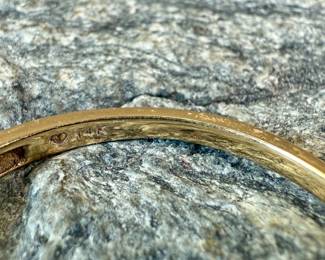 This lot features a 14k gold band with diamonds in a size 8.5 with a total approx. weight of 1.63 grams.
