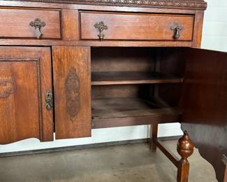 This lot features an antique Quarter-Sawn Oak sideboard with two dove tailed drawers and two cabinets with shelving. Minor wear throughout, but in good overall condition and measures, 42.5” H x 47.5” W x 17.25” D.
