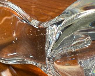 This lot features a set of two Steuben Crystal beaver figurines with garnet eyes, designed by Lloyd Atkins for Steuben in 1975. Comes with a pair of Steuben boxes. 
