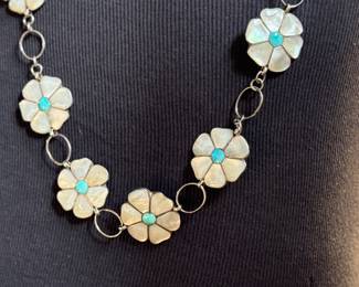 This lot features a vintage Zuni Native American concho belt made of sterling silver with mother-of-pearl and turquoise inlay with a floral design. Measures 42” with a total approx. weight of 196.41 grams.
