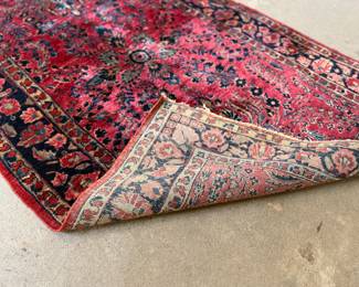This lot features an antique handwoven Sarouk rug that measures, 74” H x 48” W.
