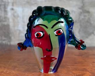 This lot features an Italian Murano glass face sculpture, circa 1970s. This sculpture is in good overall condition and measures, 10.5” H x 11.5” W x 3.5” D. There is a small chip on the lower base shown in photos that is hardly noticeable.
