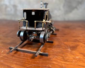 This lot features a unique handcrafted locomotive sculpture made of various metals and salvaged materials. It has a brass plaque mounted on top from Jacksonville, Oregon. This sculpture measures, 6” H x 13” W x 5” D.
