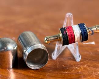 This lot features an antique sterling silver thread holder, manufactured and signed by Napier. The sterling case alone weighs approx. 19.53 grams.
