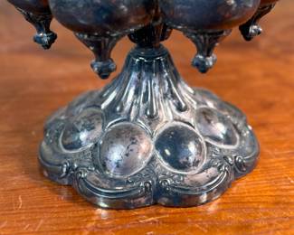 This lot features an antique Meriden Brittania cruet, with maker marks underneath as shown in photos. This cruet has seven (7) misc. containers included, some of which appear to have silver accents. Measures, 18” H x 8” W x 8” D.

