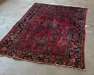 This lot features an antique handwoven Sarouk rug that measures, 74” H x 48” W.
