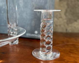 This lot features four (4) pieces of Steuben “twist”, including a pair of candlesticks, a vase, & a bowl. Comes with one large box to store them in. 
