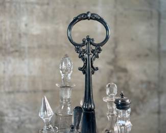 This lot features an antique Meriden Brittania cruet, with maker marks underneath as shown in photos. This cruet has seven (7) misc. containers included, some of which appear to have silver accents. Measures, 18” H x 8” W x 8” D.
