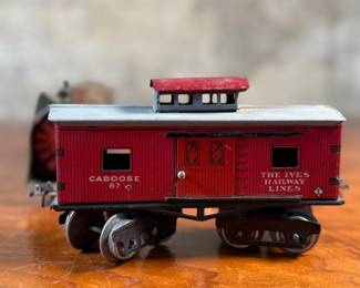 This lot features a collection of three (3) vintage toy train cars, most likely manufactured by Ives Railway Lines. One is marked, “Germany” underneath as shown in photos. All of them appear to be O gauge models.
