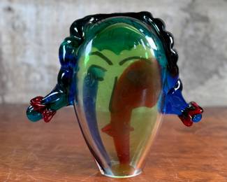 This lot features an Italian Murano glass face sculpture, circa 1970s. This sculpture is in good overall condition and measures, 10.5” H x 11.5” W x 3.5” D. There is a small chip on the lower base shown in photos that is hardly noticeable.
