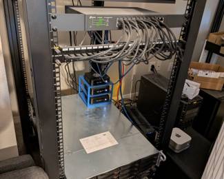 Professional Server Rack with Networking Equipment
StarTech professional server rack with networking equipment, patch panels, routers, and cable management. IT equipment, home lab setup, network infrastructure, tech hardware.