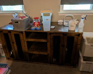 $500 Rustic Wood Pet Station with 2 Dog Crates built in
Rustic wooden console table with cabinet storage, currently set up as pet feeding station with Kong toys, treats container, and pet supplies. Farmhouse furniture, pet organization, wooden sideboard.