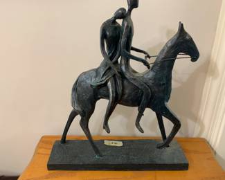 #66 metal statue 2 people on back of horse 14 tall $30.00