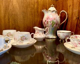 Vintage porcelain tea cups and saucers, and vintage chocolate pot.