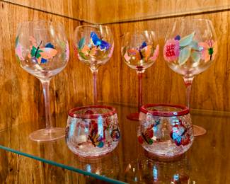 Hand painted butterfly-themed wine glasses, two butterfly-themed candle holders.