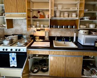 Various kitchen items; cooking trays; Pyrex, glass and metal pie plates; Bundt pans; muffin tins; roasting pans; colanders; Oster blender ...and more!