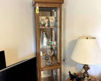 Skinny lighted display cabinet, Hull pottery pieces