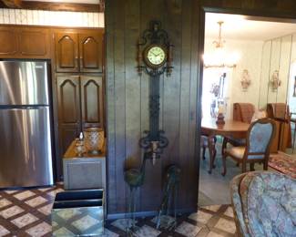 Decorative wall clock with wrought iron pendulum, pair of metal crane statues