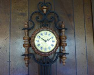 Decorative wall clock with wrought iron pendulum