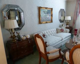 Traditional tufted back sofa, oval coffee table, pair of accent chairs, pair of Karges side chests, pair of mirrors, oil painting signed by Joan Giralt Lerin, pair of lamps