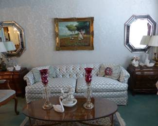 Traditional tufted back sofa, oval coffee table, pair of accent chairs, pair of Karges side chests, pair of mirrors, oil painting signed by Joan Giralt Lerin, pair of lamps, bric-a-brac
