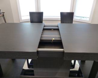 Contemporary designer dining table with 6 designer leather chairs (leaf is stored in the table)