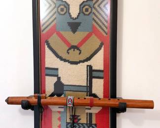 Large-scale framed needlepoint kachina holding wooden flute