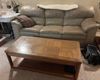Oak coffee table with glass top and tan leather couch