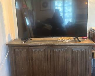 Amazon television with remote ($100) and wooden credenza ($50). Please bring trucks and helpers to move items.