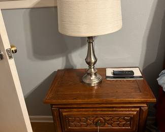 Nightstand and lamp in primary bedroom 