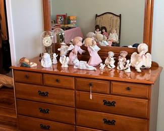 Maple dresser with an array of angel figurines 
