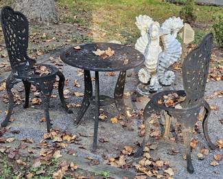 Outdoor ornamental iron table and chairs (set) and bird bath base sold separately.