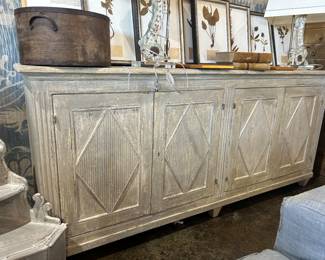 This is a Louis XVI-style enfilade sideboard with a painted, distressed finish