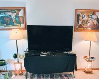 65in Vizio television with Vintage floor lamps with tables.