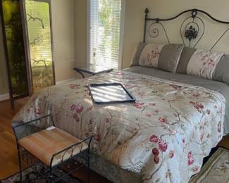 Beautiful queen bed, mattress and box spring included if you was. There is a footboard as well. Great metal accessories in the primary bedroom
