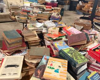 Two tables stacked full of books