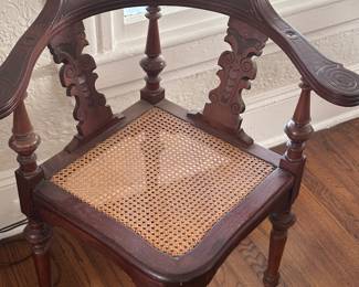 Corner chair with cane seat.