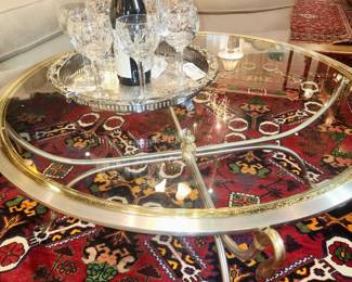 Antique Persian area rug, deco style chrome and brass glass top coffee table