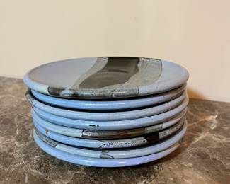 E99 - $100. Set of 8 "HOWE" Pottery Dinner Plates. Measures 8.5" across.