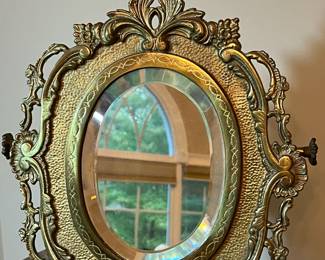 E73 - $40. Heavy Brass Table Mirror. Single sided mirror but does adjust up & down. Measures 11.5" x 17.5" tall.