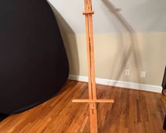 E64 - $40. Adjustable Wooden Floor Easel. Measures 24.75 x 72" tall.
