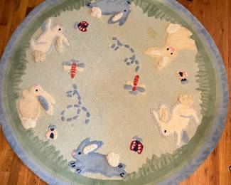E52 - $50. Pottery Barn Kids Area Rug. Measures 60". Needs cleaned.