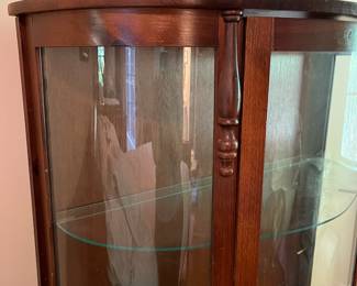 E44 - $100. Bow front curio with 3 glass shelves. Measures 34.5" wide x 14.25" deep x 57" tall.