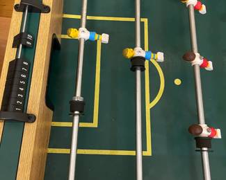 E109 - $50. Foosball Table. Was stored in the attic so the legs were already off. Legs, Hardware & Game Table all included.