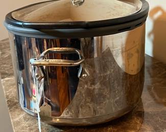 E117 - $100. All Clad Crock Pot. Lid has a dent on the rim - see photo.
