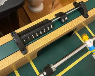 E109 - $50. Foosball Table. Was stored in the attic so the legs were already off. Legs, Hardware & Game Table all included.