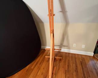 E64 - $40. Adjustable Wooden Floor Easel. Measures 24.75 x 72" tall.