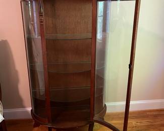 E44 - $100. Bow front curio with 3 glass shelves. Measures 34.5" wide x 14.25" deep x 57" tall.
